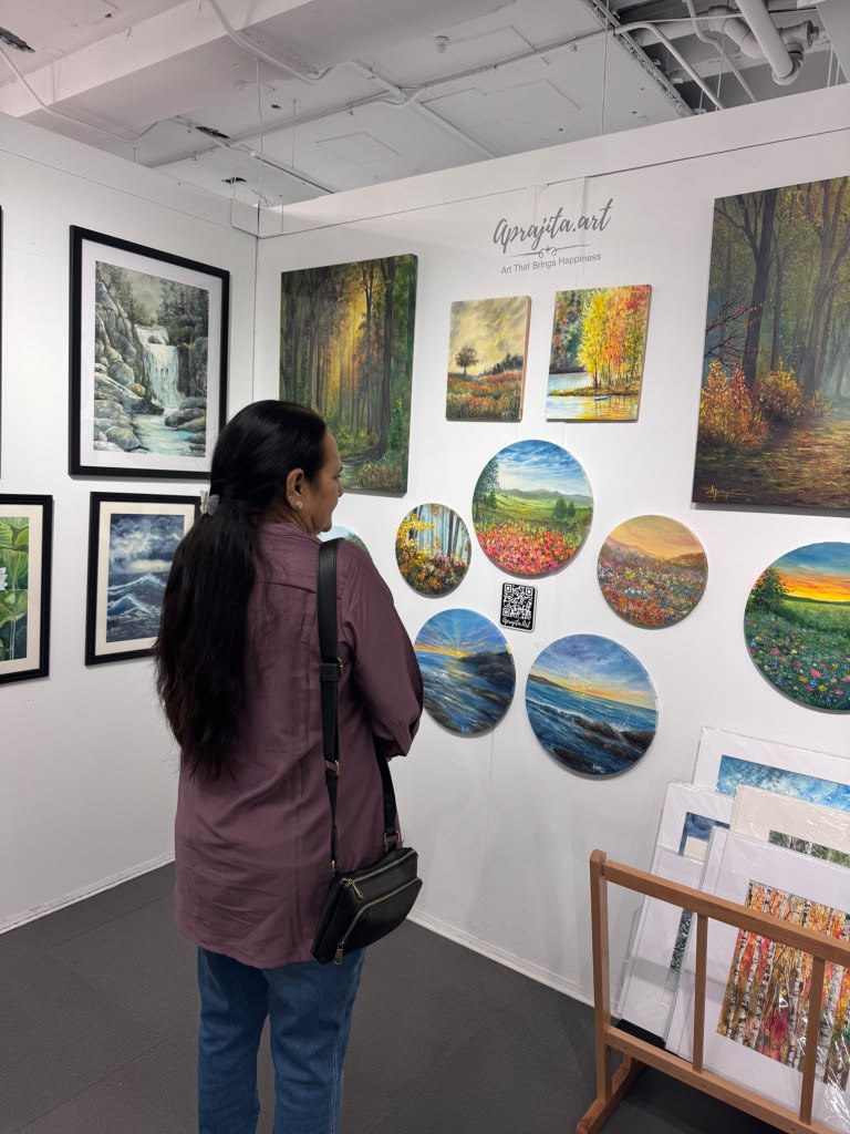 A guest viewing a gallery wall of framed artworks